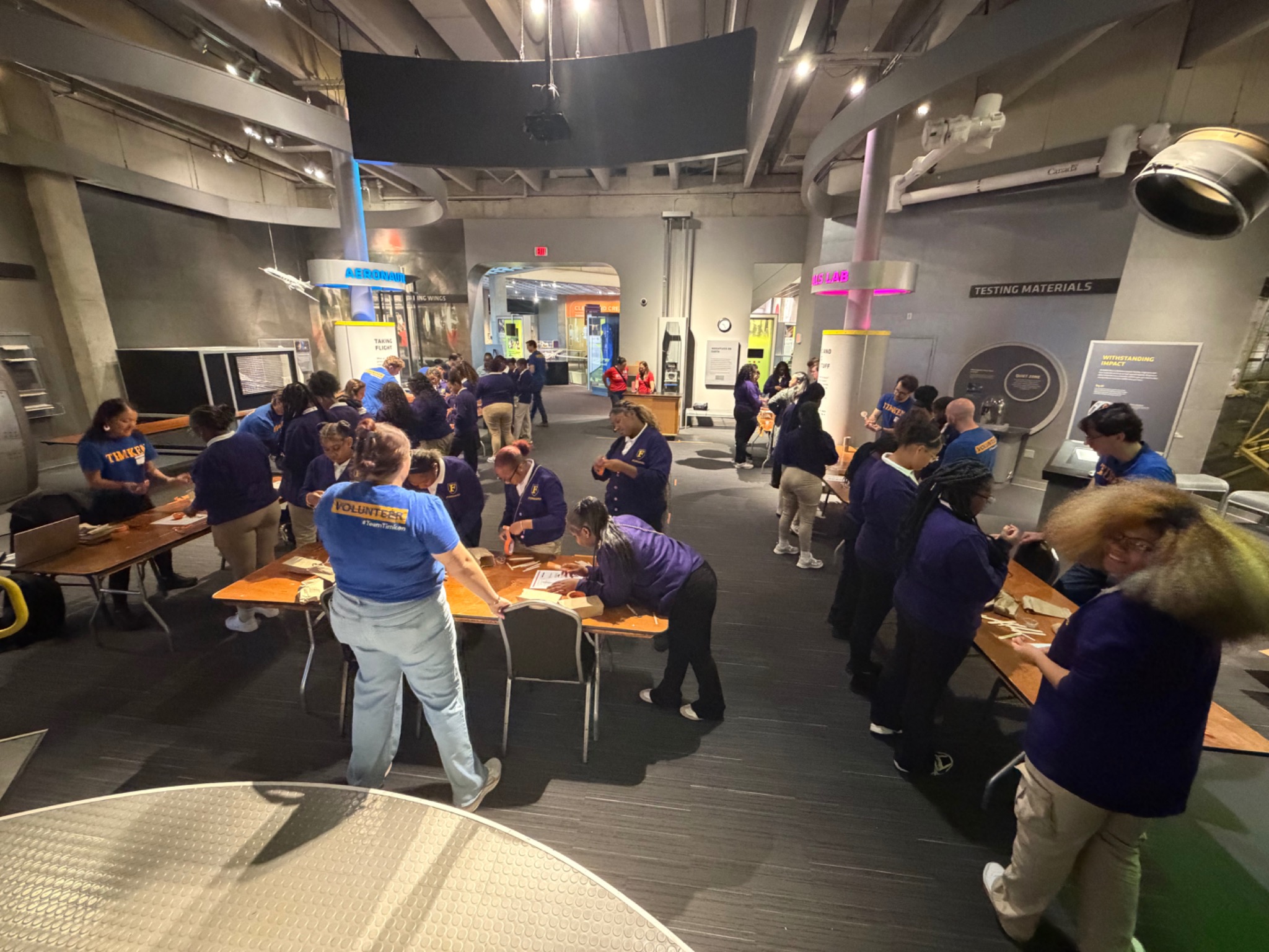 Students collaborating on projects at a science exhibit