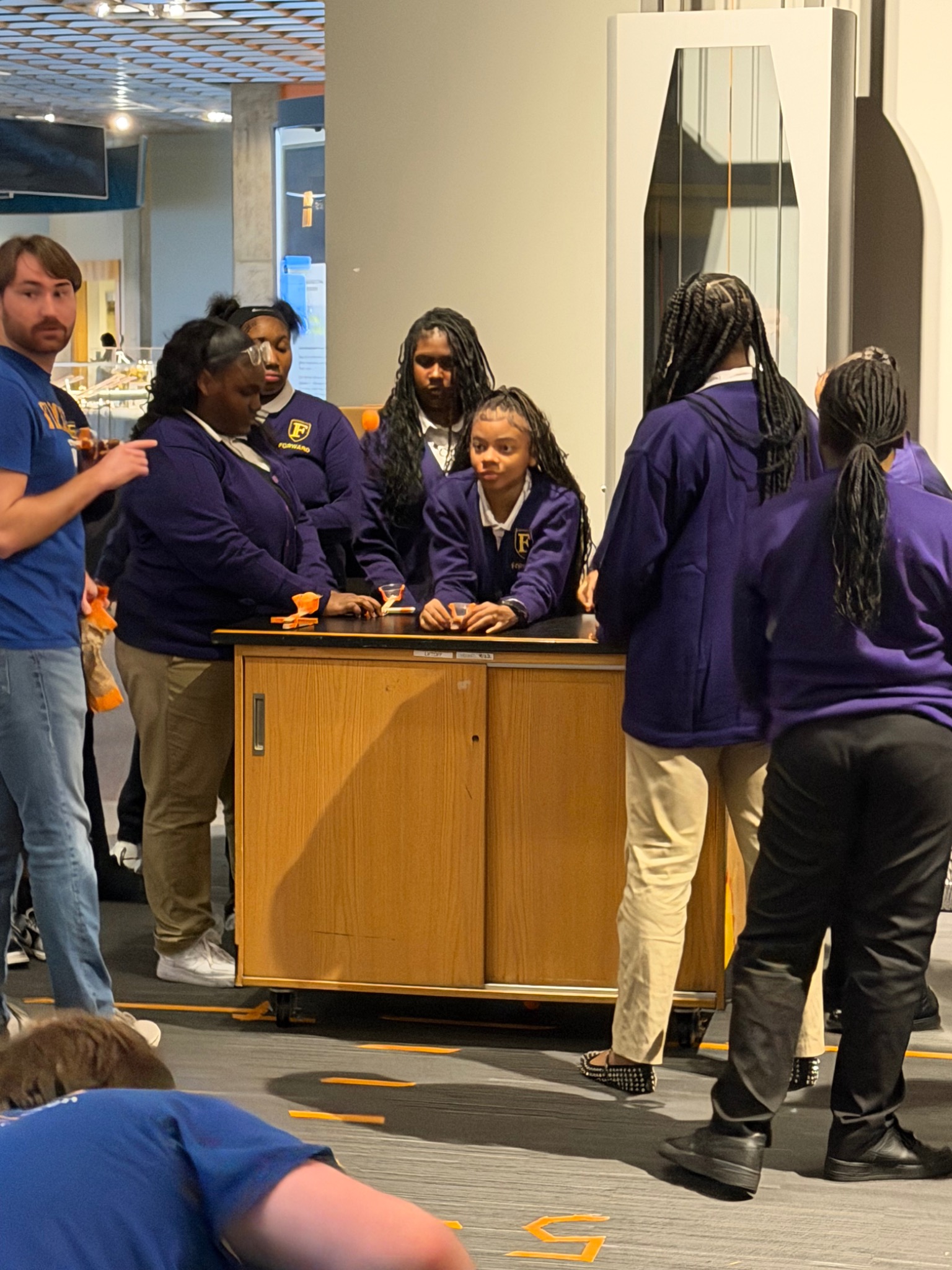 Students gathered around a science activity station